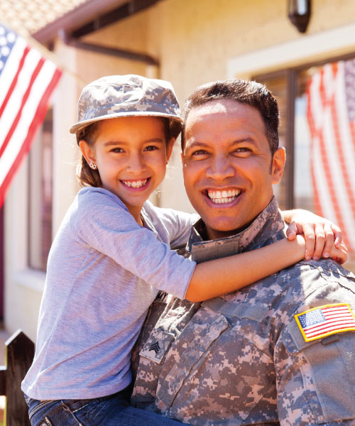Soldier with child smiling at home