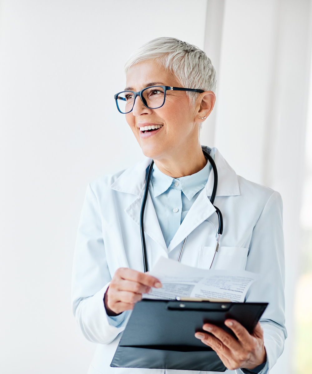 doctor smiling with clipboard