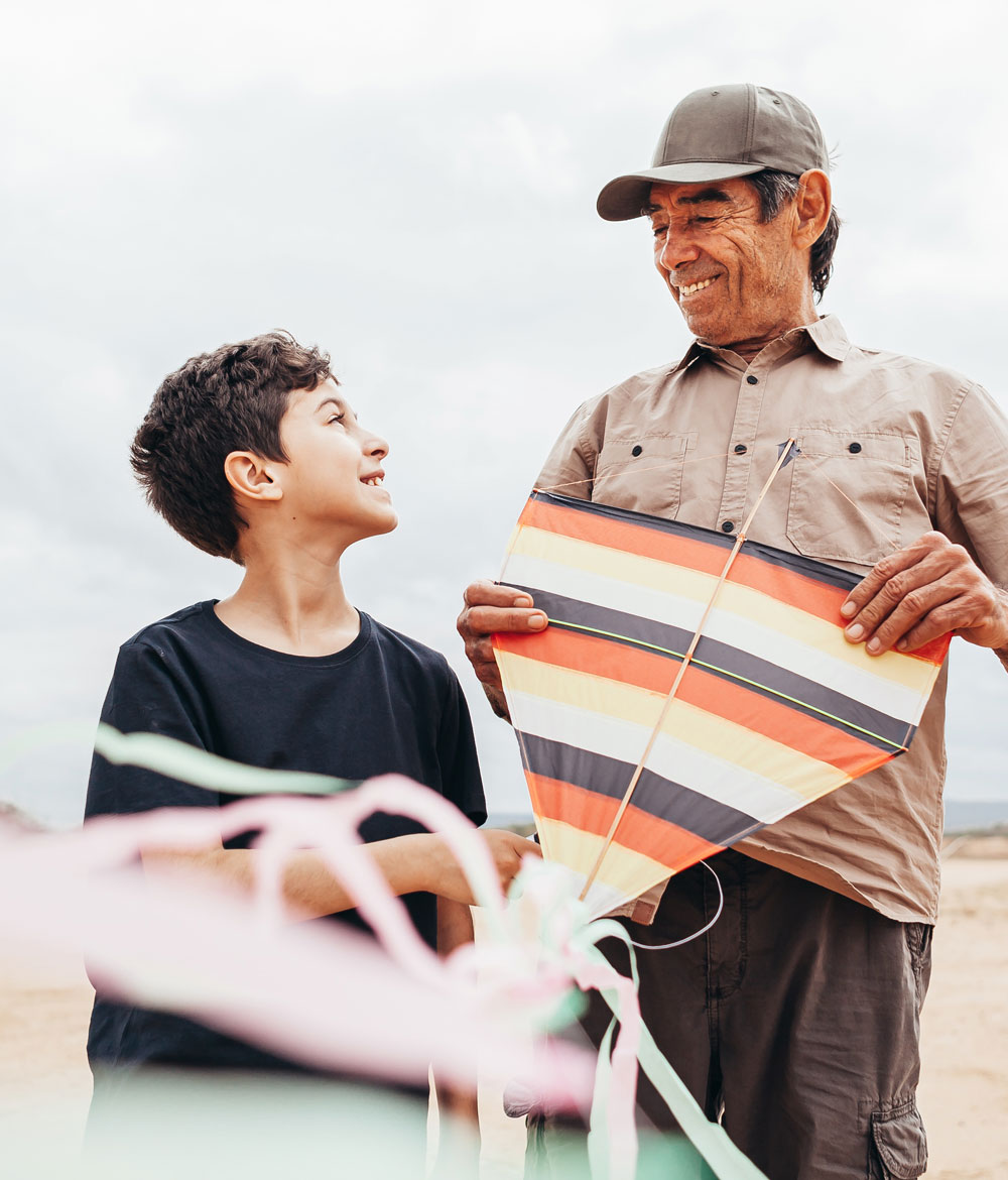 grandfather and grandson with kite outdoors