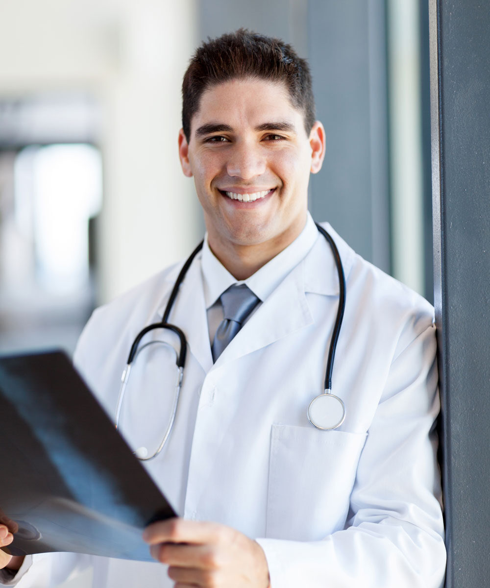 doctor holding CT scan film in hospital