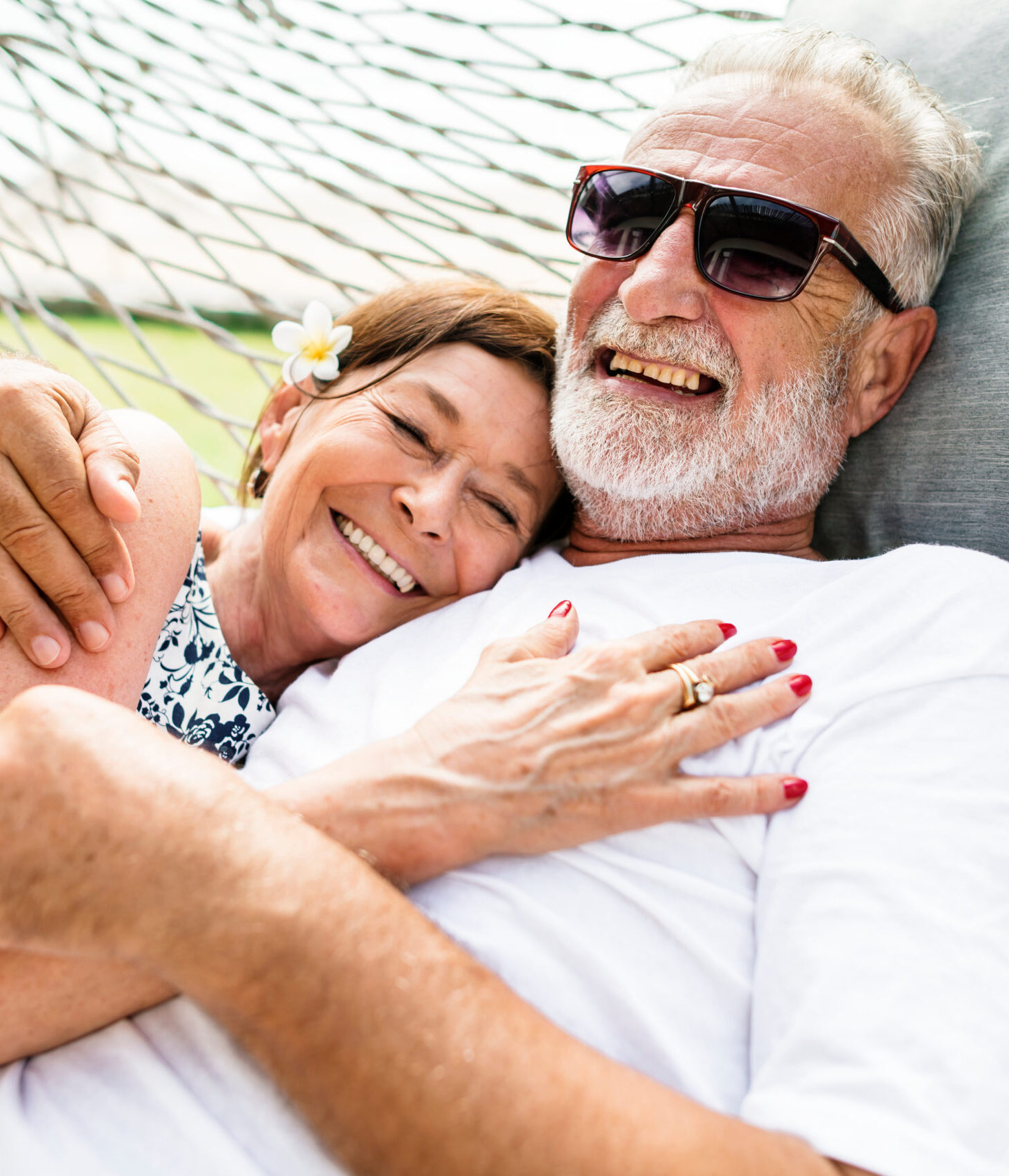 senior couple laughing in a hammock