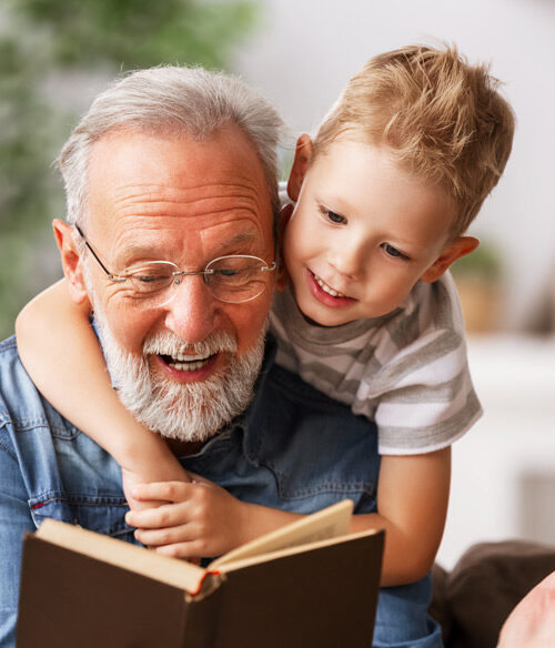grandfather reading to grandchild