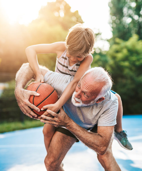 grandpa playing basketball with his grandson and getting a bit roudy